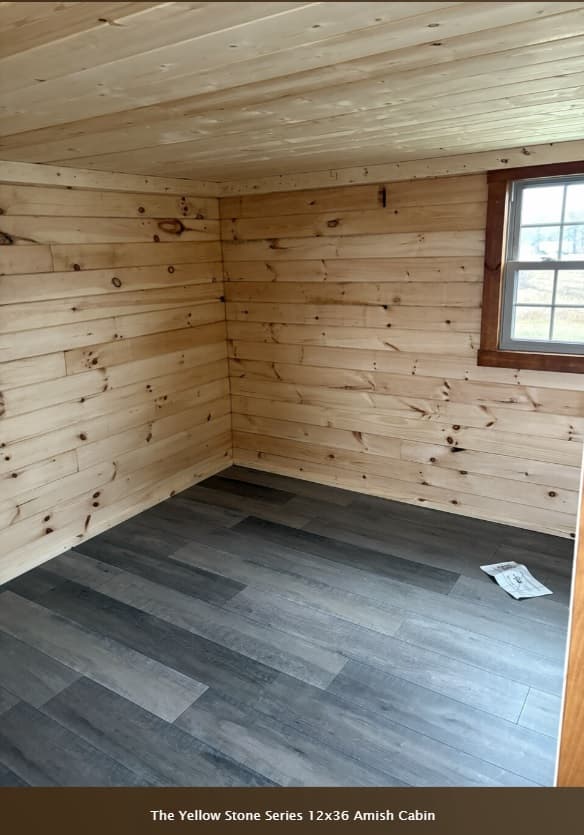 Yellowstone 12x36 cabin bedroom with natural pine wood walls and single window