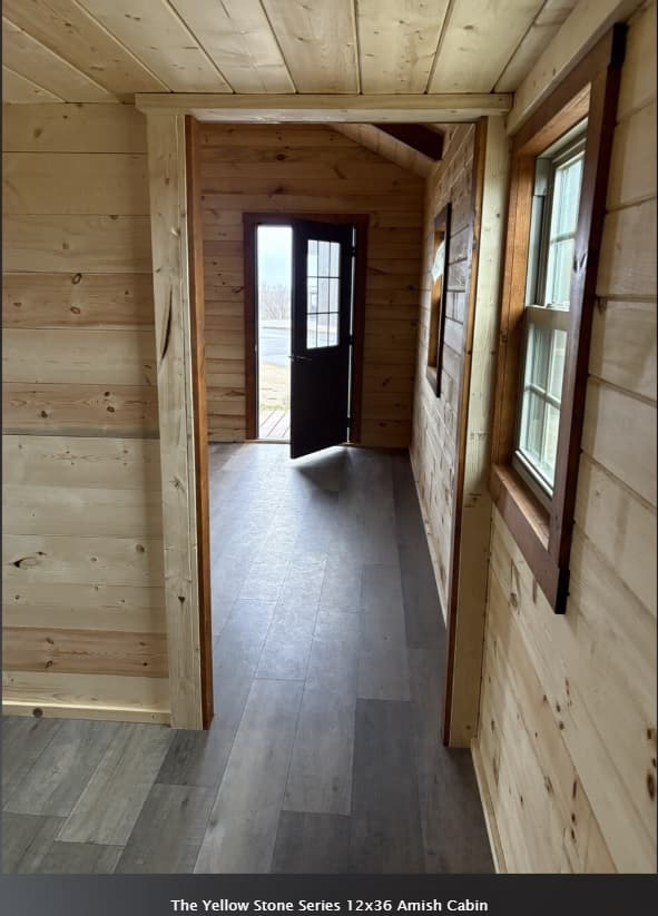 Yellowstone 12x36 cabin hallway and entryway with natural wood walls and multiple windows